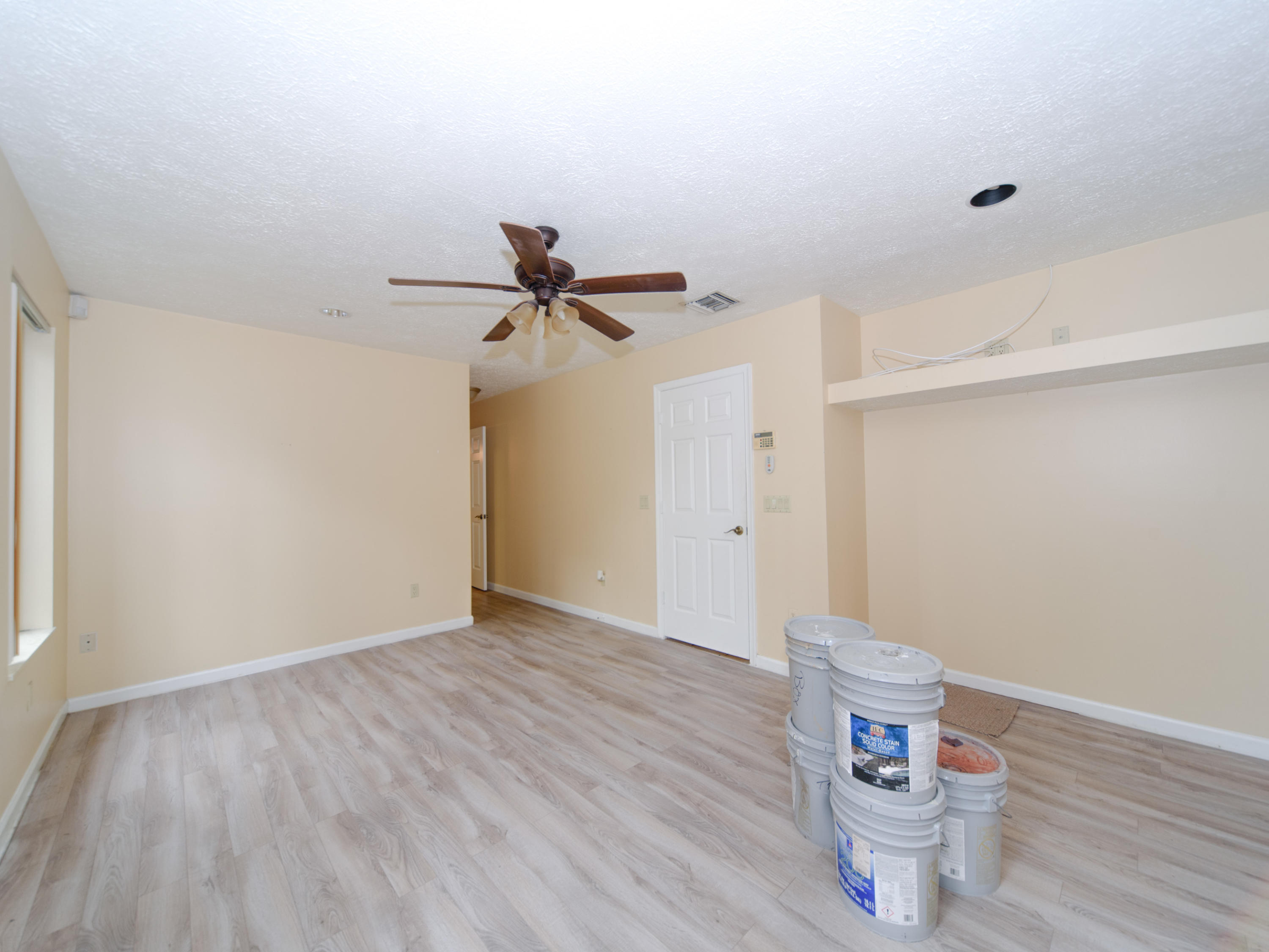 2477 West G Road Loxahatchee, FL 33470 - Photo 58 of 61 a view of an empty room with a window and wooden floor