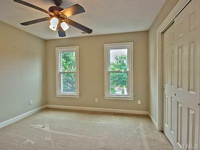 2405 Cookshire Drive Raleigh, NC 27604 - Photo 15 of 25 Bedroom 2 has carpet, ceiling fan & a closet. This would be a great place for a guest room.