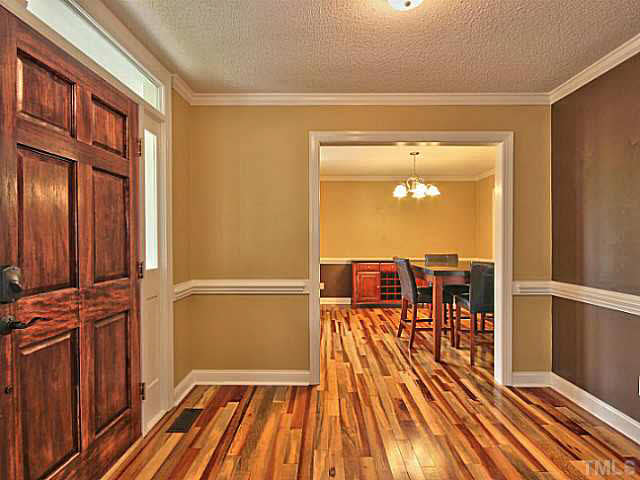 2405 Cookshire Drive Raleigh, NC 27604 - Photo 3 of 25 When you enter your new home you are greeted by this foyer with these gorgeous Brazilian Tigerwood floors that run throughout the downstairs.