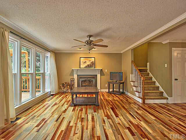 2405 Cookshire Drive Raleigh, NC 27604 - Photo 9 of 25 Your kitchen opens into your family room. It has a wood burning fireplace with mantle & a ceiling fan. This is a great place for movie or game night.