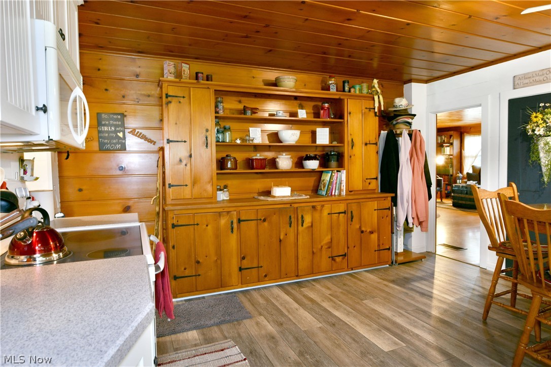 8683 King Graves Road Northeast Warren, OH 44484 - Photo 9 of 50 Integrated wood-finish cabinetry and shelving unit with dark hardware