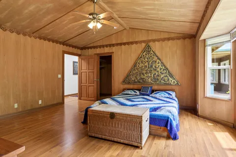 a bedroom with a bed and a chandelier