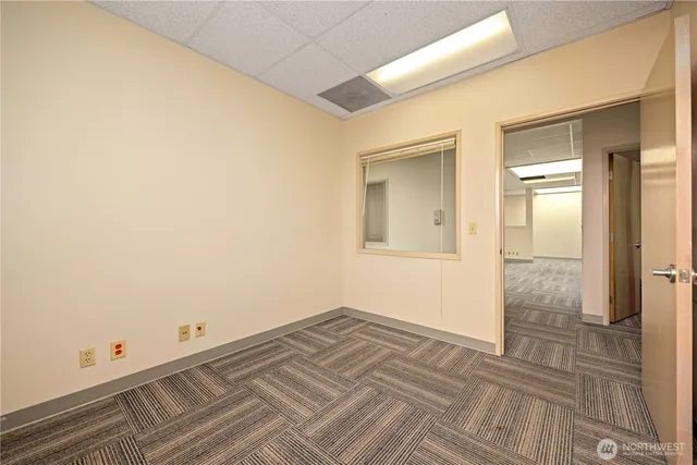 a view of a room with wooden floor and brick wall