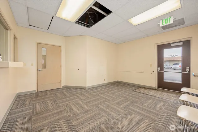 a view of a room that has a bed and a window