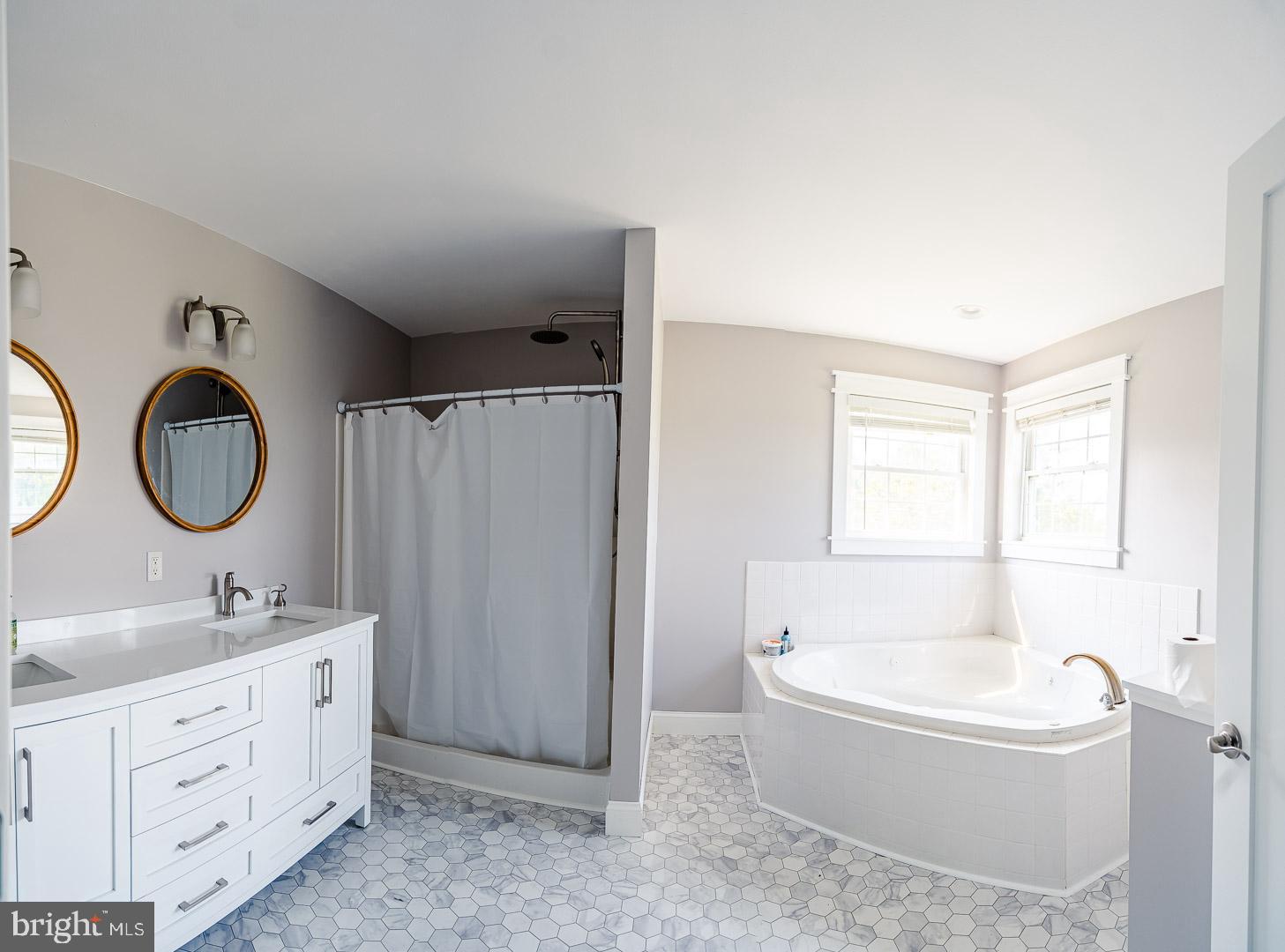 6825 Briscoe Turn Road Owings, MD 20736 - Photo 32 of 47 a bathroom with a tub sink and mirror
