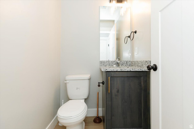 226 South 600 West Logan, UT 84321 - Photo 8 of 25 Half bathroom featuring vanity and wood finished floors