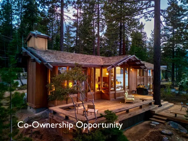 a view of a house with backyard water fountain and sitting area