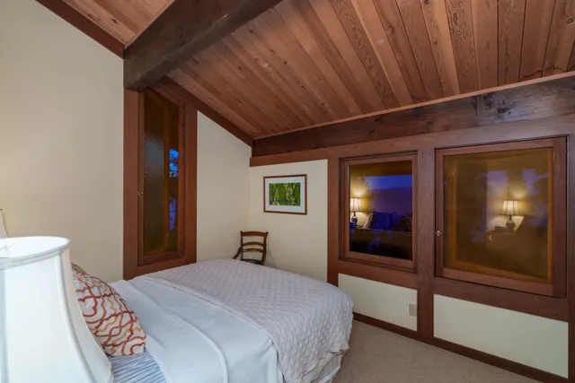 a yellow house with tree in front of it