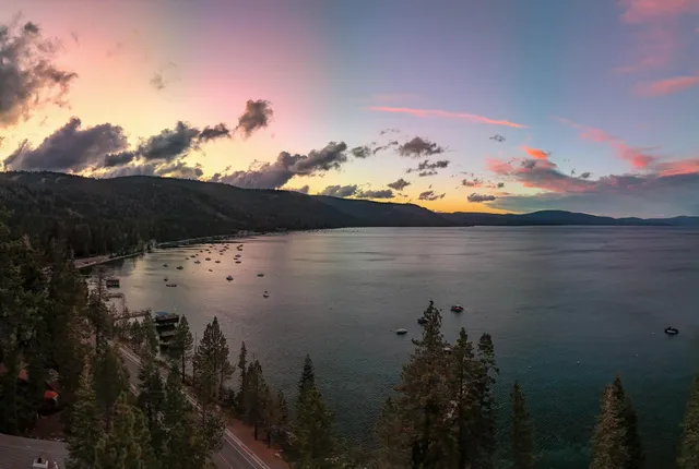 a living room with furniture a rug and a floor to ceiling window