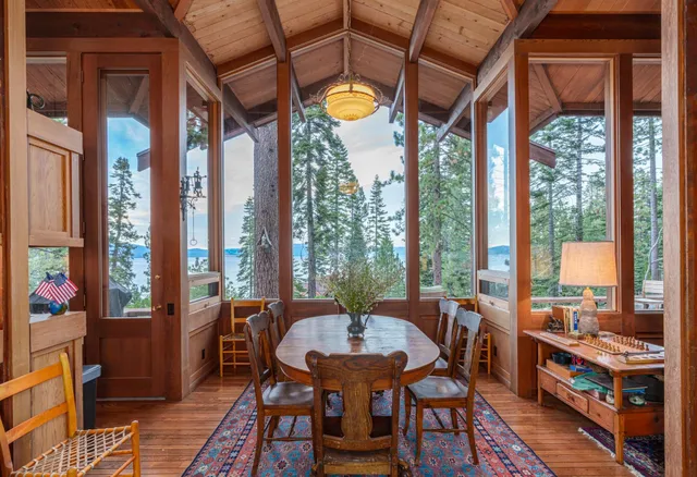 a living room with furniture a fireplace and a floor to ceiling window