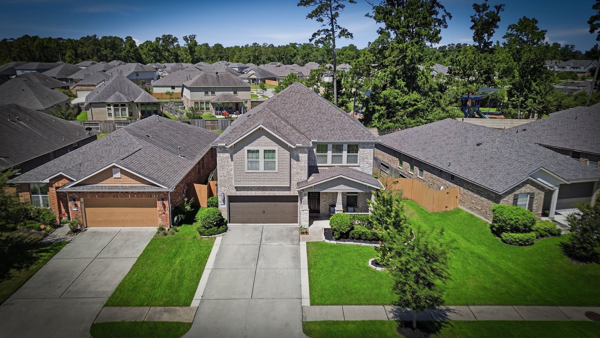 4334 Umber Shadow Drive Spring, TX 77386 - Photo 40 of 45 Aerial view showcases the home's prominent placement within the neighborhood, highlighted by a spacious backyard, manicured landscaping, and attractive curb appeal.