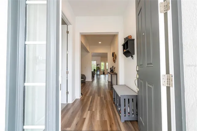a large kitchen with stainless steel appliances lots of counter space and wooden floor