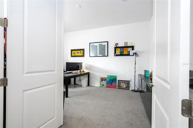 a kitchen with refrigerator a sink white cabinets and wooden floor