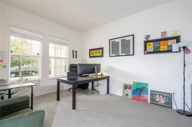 a view of a livingroom with wooden floor and furniture