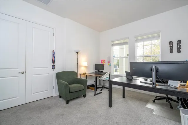 a bed sitting in a bedroom next to a window