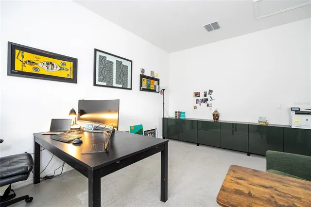 a bedroom with a bed and a painting on the wall