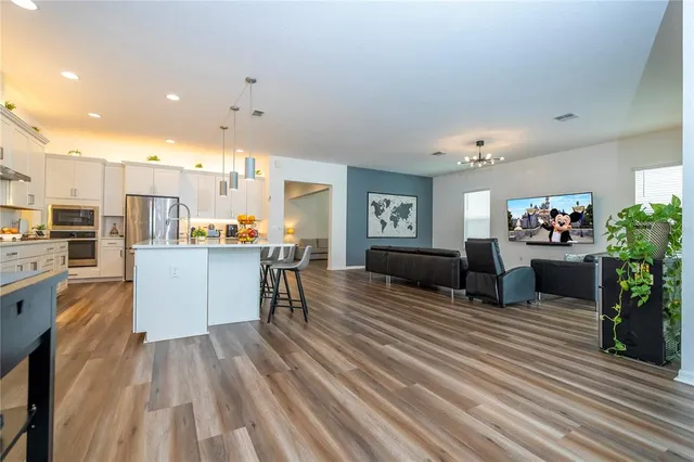 a spacious bathroom with a double vanity sink a mirror and a bathtub