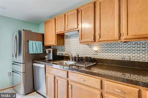17 Devon Court Sterling, VA 20165 - Photo 14 of 30 a kitchen with stainless steel appliances granite countertop a sink stove and refrigerator