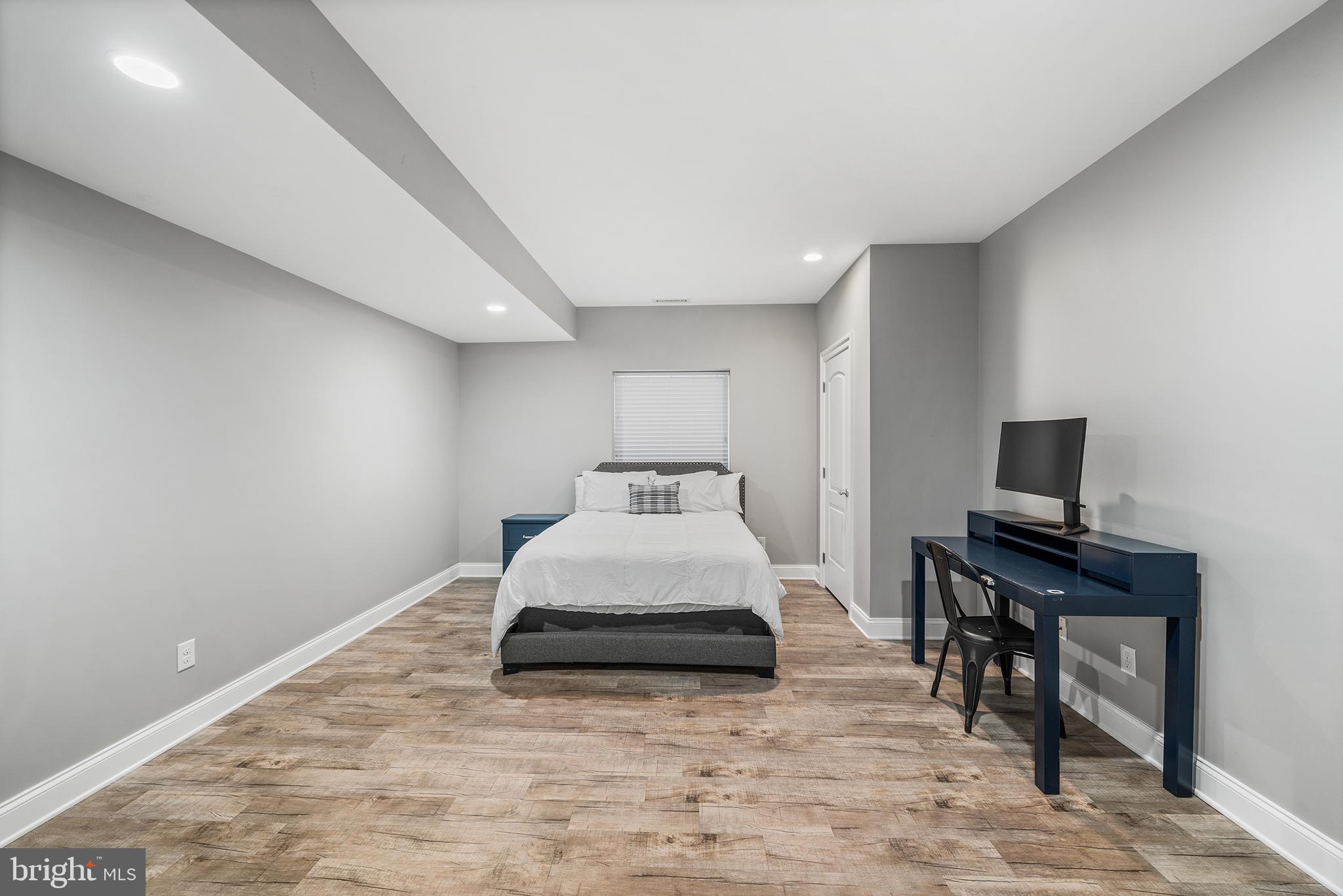515 Old Eagle School Road Wayne, PA 19087 - Photo 33 of 40 a bedroom with a bed and a flat screen tv