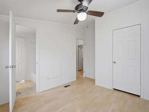 a view of a room with a ceiling fan and a shower