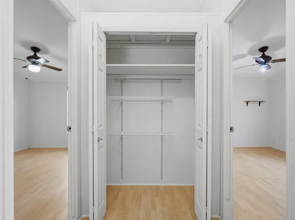 a view of a hallway with wooden floor