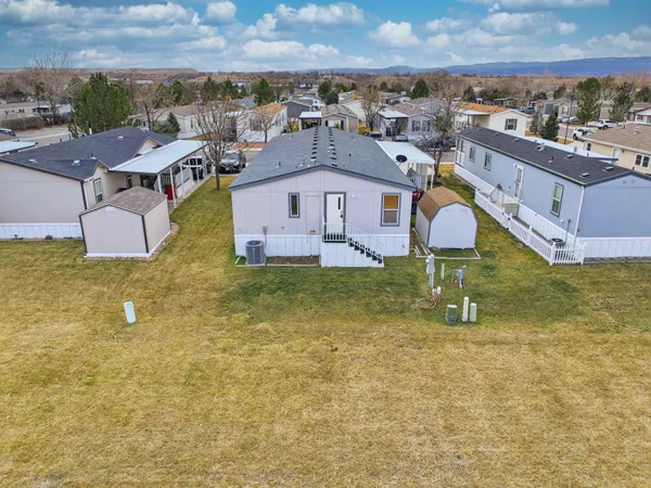 an aerial view of residential houses with outdoor space and swimming pool