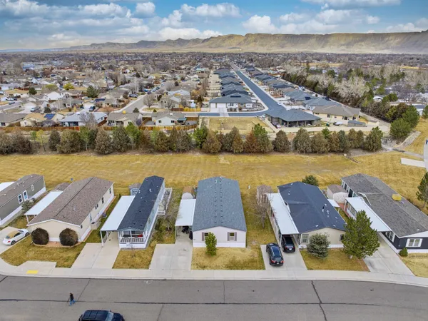 an aerial view of residential houses with outdoor space and ocean view