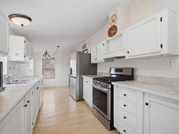 a kitchen with stainless steel appliances granite countertop a stove and a sink