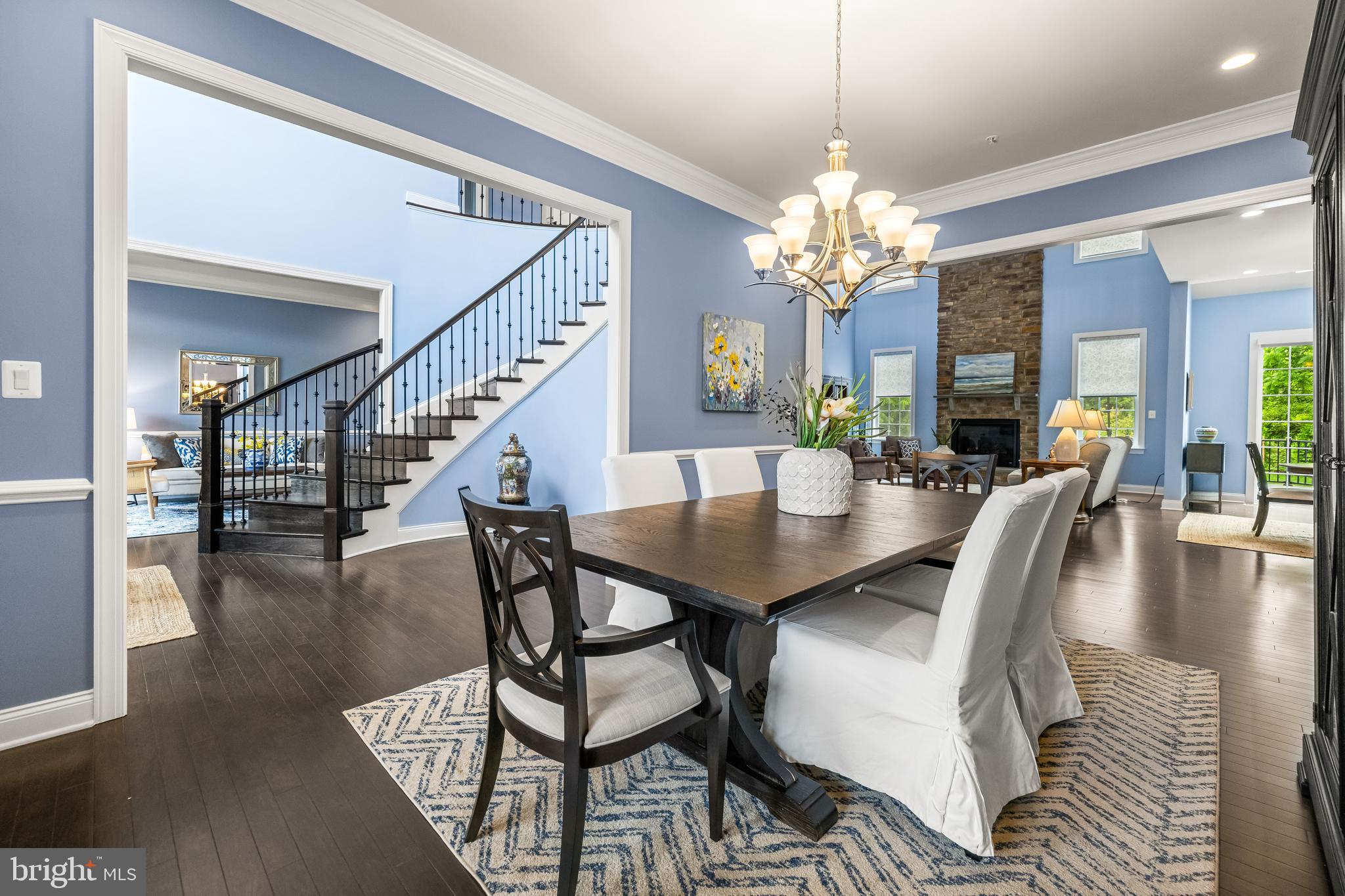 14309 Oak Meadow Road Baldwin, MD 21013 - Photo 25 of 102 a view of a dining room and livingroom with furniture wooden floor a chandelier and a rug