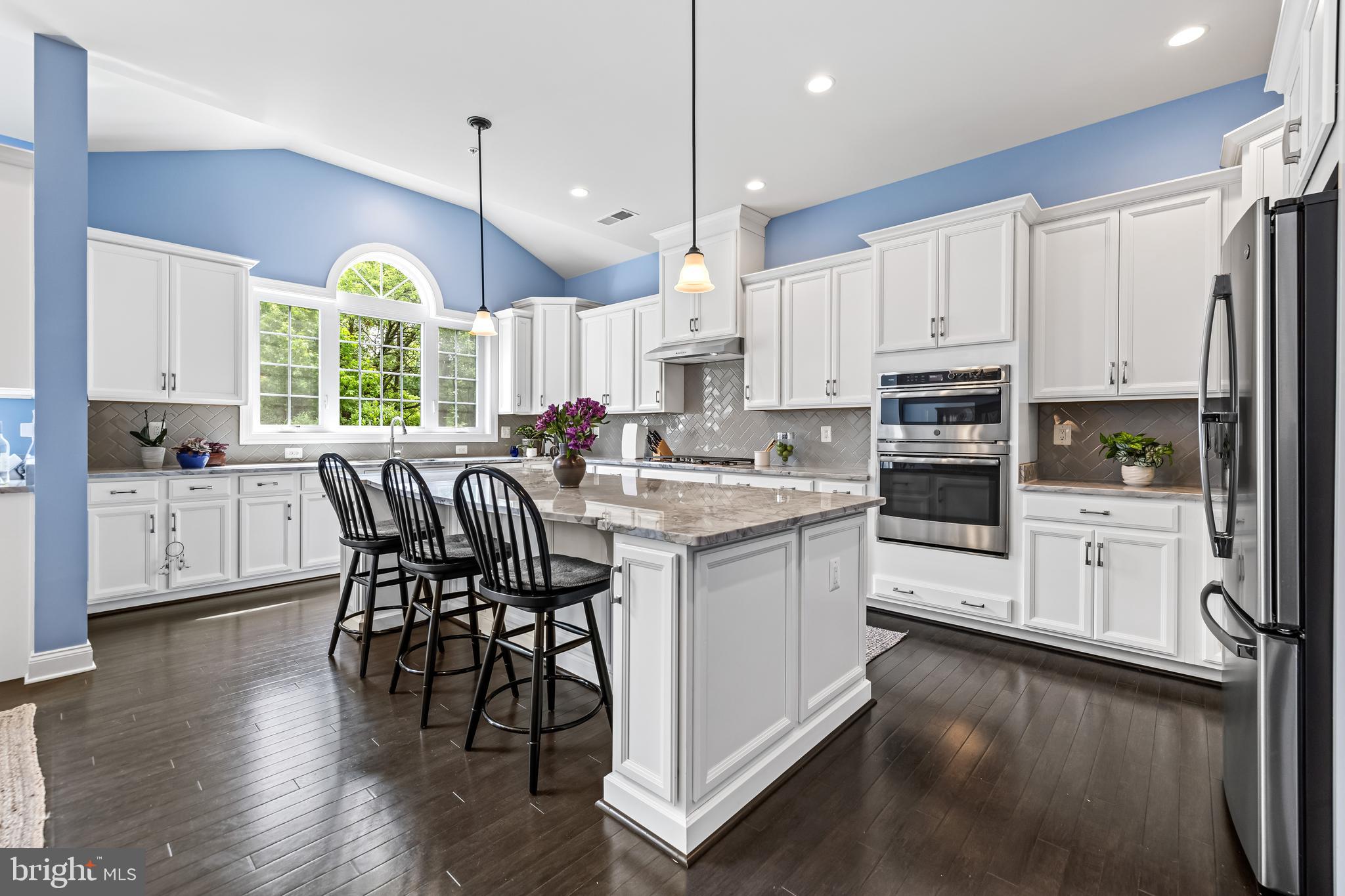 14309 Oak Meadow Road Baldwin, MD 21013 - Photo 32 of 102 a kitchen with stainless steel appliances kitchen island a white cabinets and wooden floor