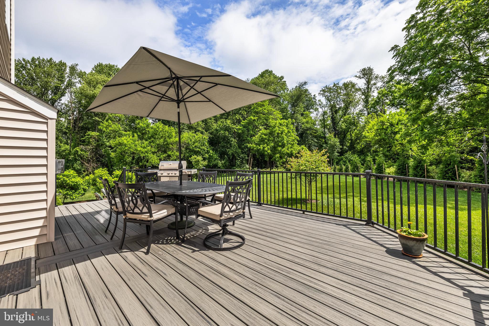 14309 Oak Meadow Road Baldwin, MD 21013 - Photo 98 of 102 a view of a roof deck with table and chairs under an umbrella with wooden floor