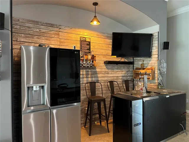 a kitchen with stainless steel appliances and refrigerator