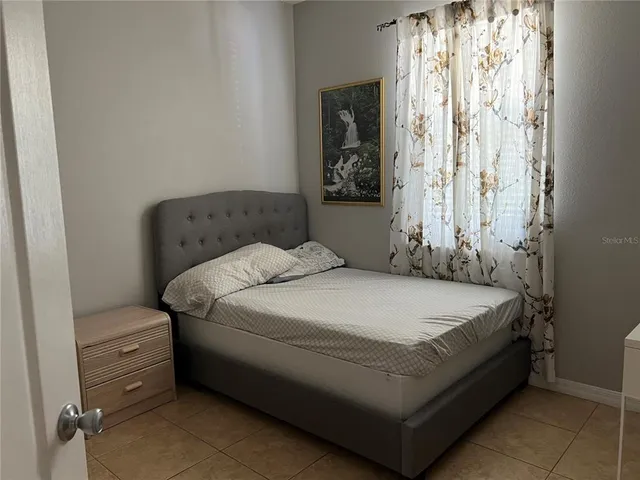 a bathroom with a granite countertop sink toilet and a mirror