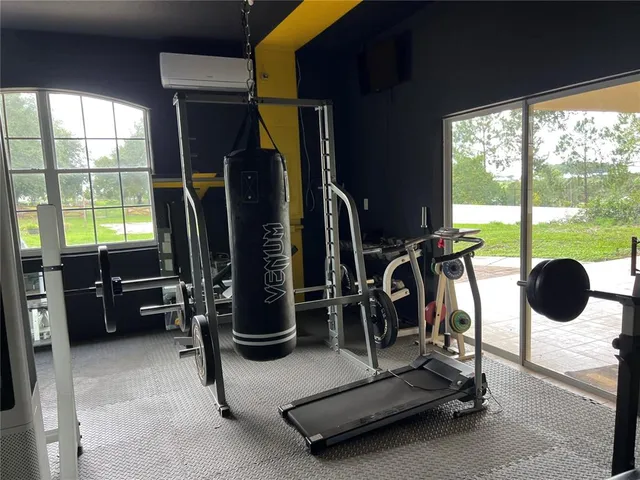 a room with gym equipment and a large window