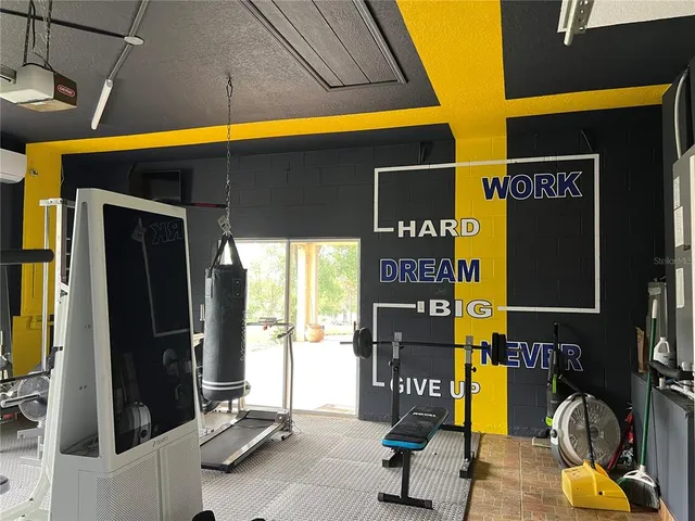 a room with gym equipment and a large window