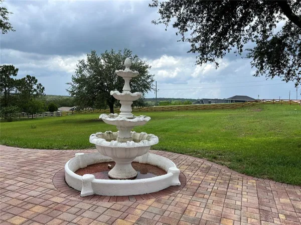 a view of a white house with garden