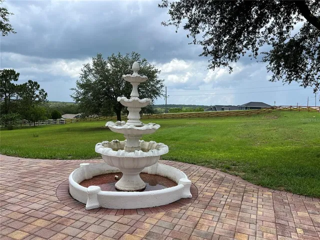 a view of a white house with garden