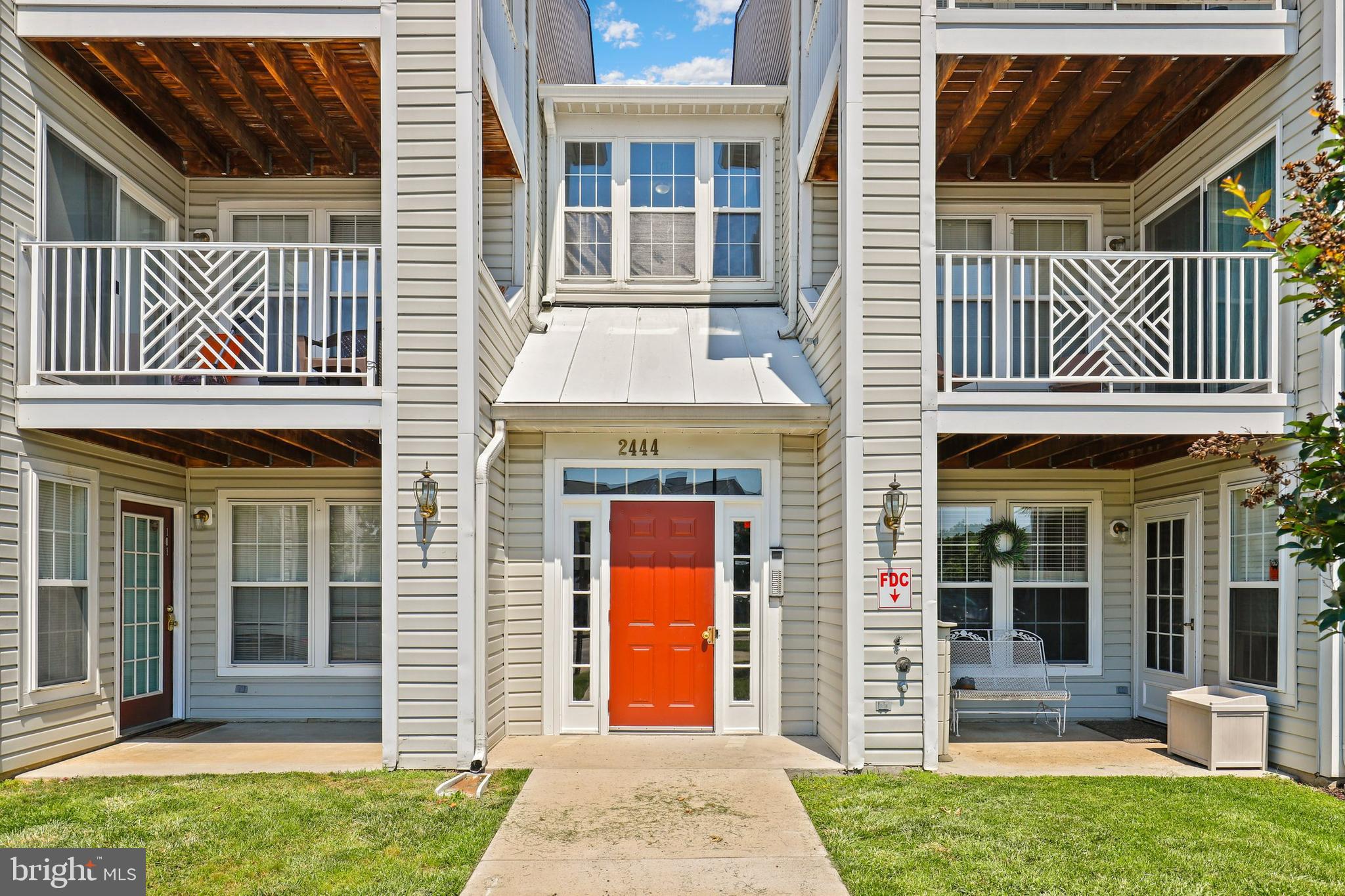 2444 Blue Spring Court, Unit 303 Odenton, MD 21113 - Photo 1 of 33 a front view of a house with a yard