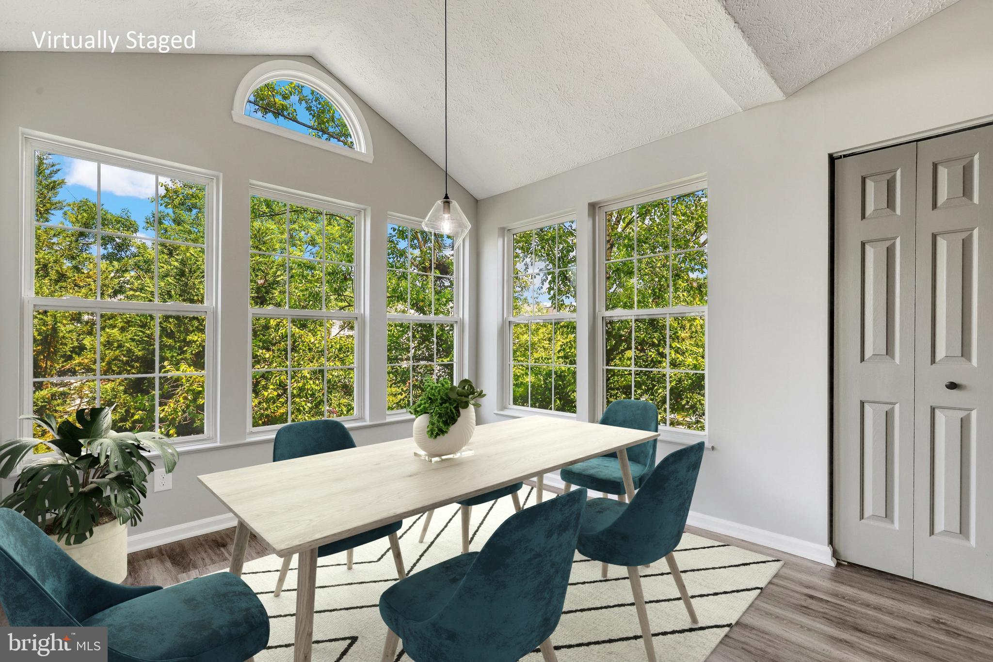 2444 Blue Spring Court, Unit 303 Odenton, MD 21113 - Photo 11 of 33 a view of a dining room with furniture window and wooden floor