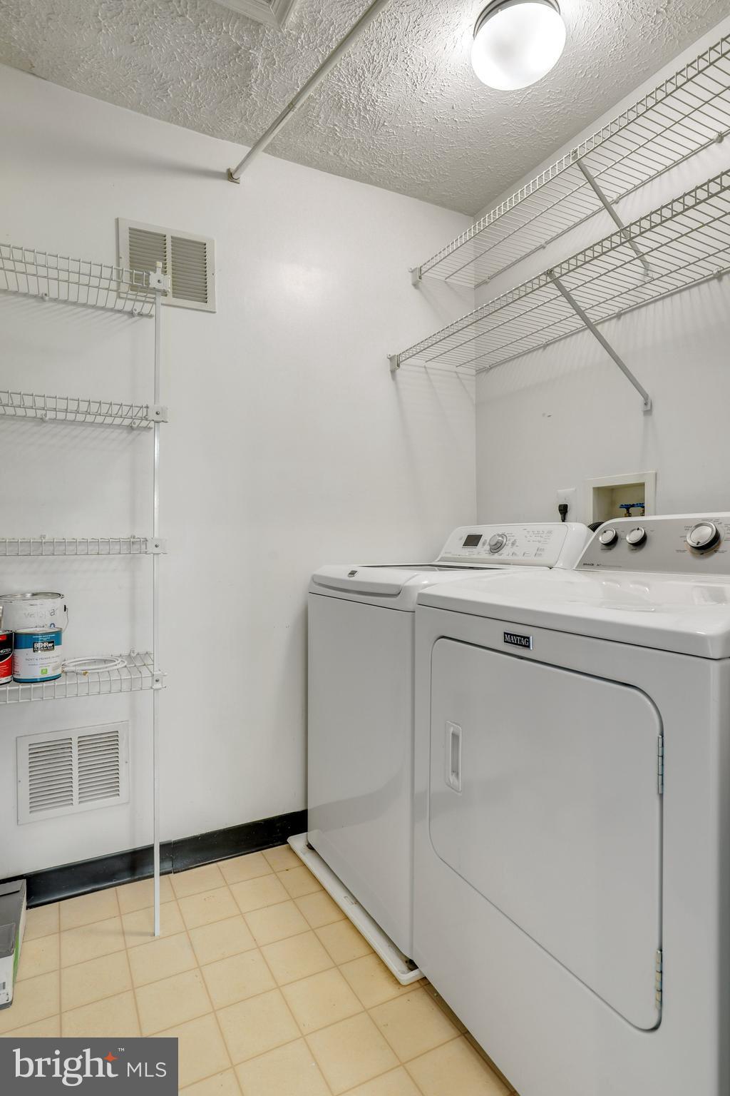 2444 Blue Spring Court, Unit 303 Odenton, MD 21113 - Photo 25 of 33 a utility room with dryer and washer