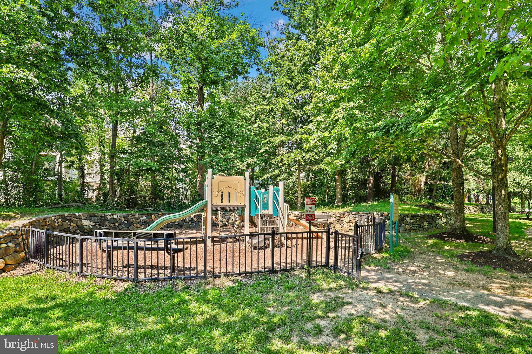 2444 Blue Spring Court, Unit 303 Odenton, MD 21113 - Photo 32 of 33 a view of a deck with two chairs and a large tree