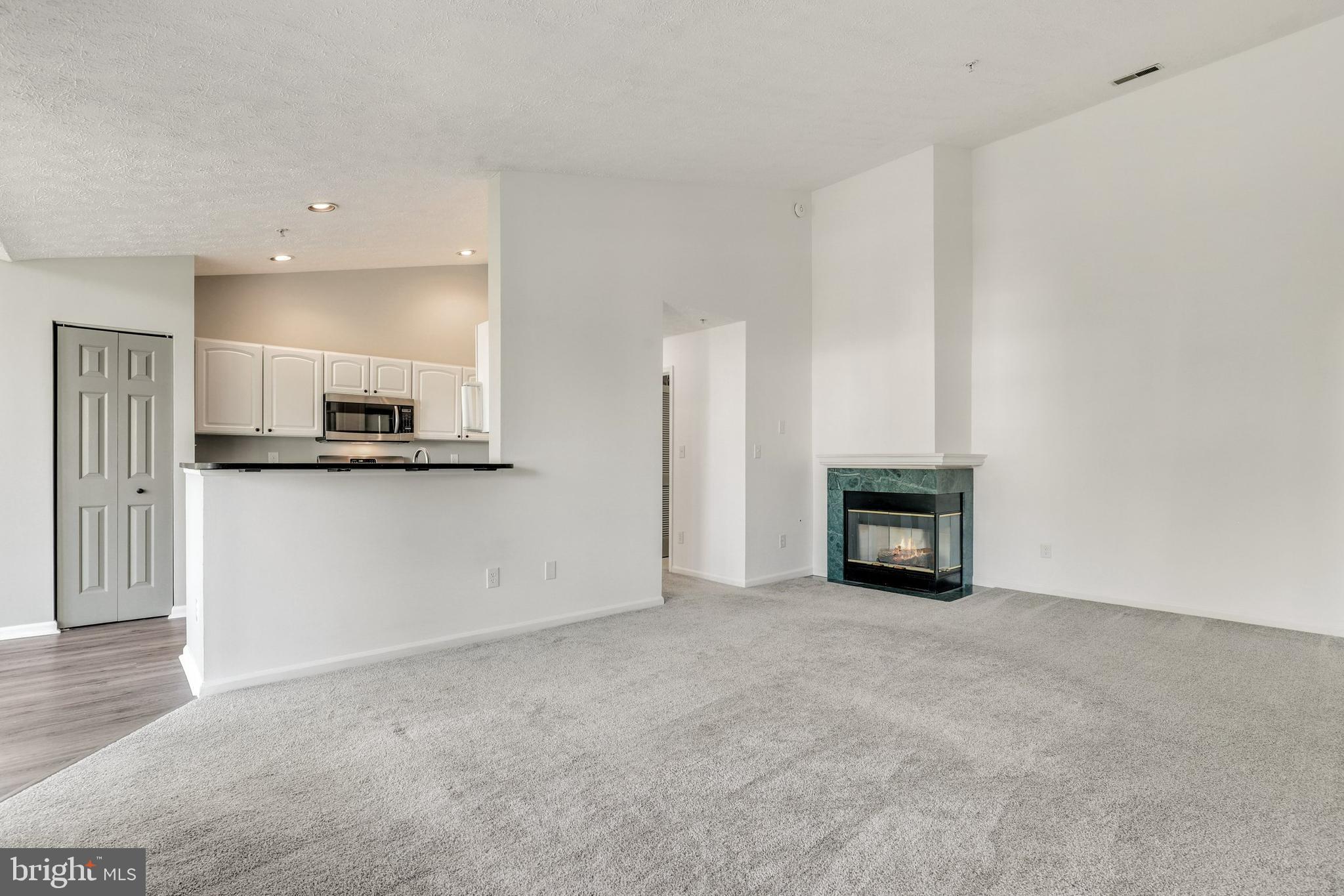 2444 Blue Spring Court, Unit 303 Odenton, MD 21113 - Photo 6 of 33 a view of an empty room with a kitchen