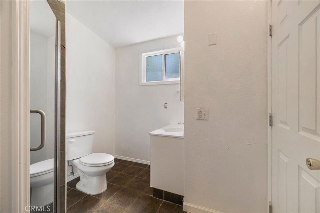 1617 Hemlock Street Chico, CA 95928 - Photo 15 of 60 a white toilet sitting next to a bathroom sink