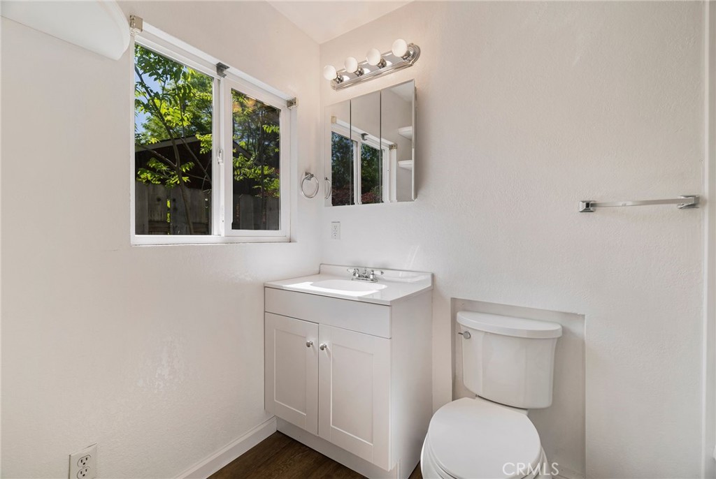 1617 Hemlock Street Chico, CA 95928 - Photo 23 of 60 a bathroom with a toilet a sink and a window