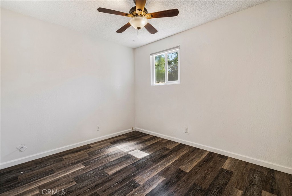 1617 Hemlock Street Chico, CA 95928 - Photo 43 of 60 an empty room with wooden floor chandelier fan and windows