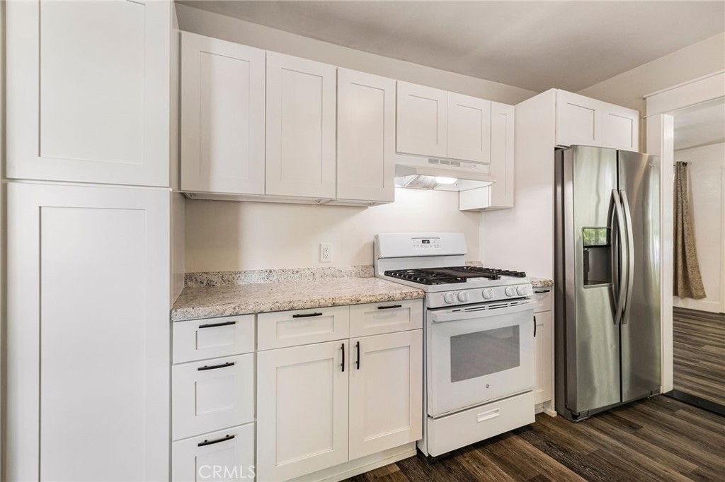 1617 Hemlock Street Chico, CA 95928 - Photo 10 of 60 a kitchen with stainless steel appliances granite countertop white cabinets and a refrigerator