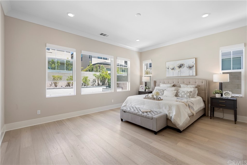 63 Crater Irvine, CA 92618 - Photo 19 of 34 a spacious bedroom with a large bed and a large window
