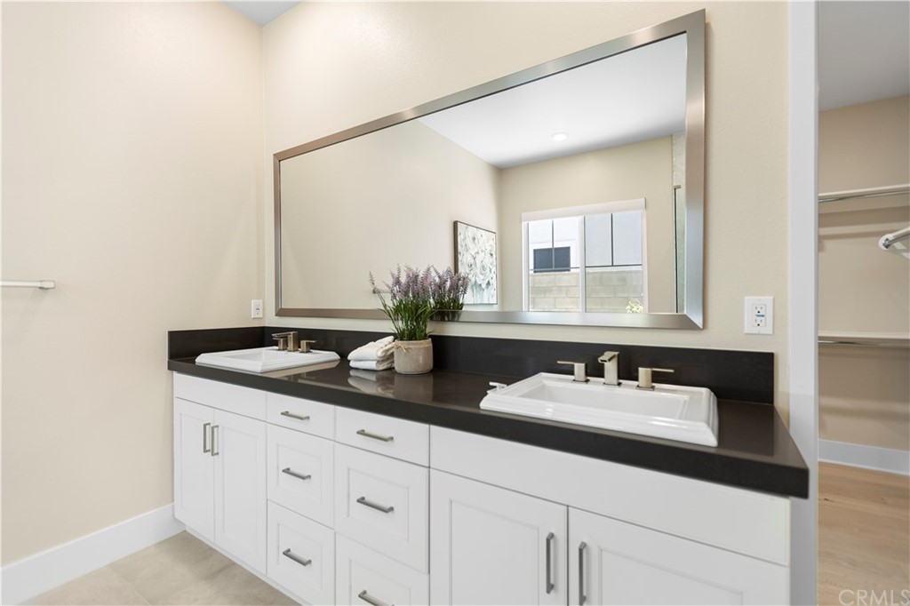 63 Crater Irvine, CA 92618 - Photo 21 of 34 a bathroom with a granite countertop sink and a mirror