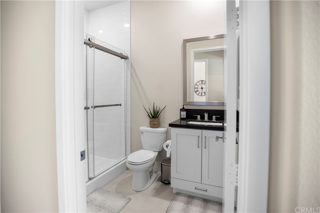 63 Crater Irvine, CA 92618 - Photo 23 of 34 a bathroom with a granite countertop sink toilet and shower