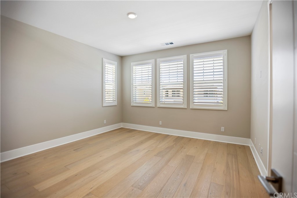 63 Crater Irvine, CA 92618 - Photo 26 of 34 a view of an empty room with wooden floor and a window